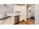 Bright kitchen featuring stainless steel appliances, granite countertops, and white cabinets at 7440 S Blackhawk St # 15-202, Englewood, CO 80112