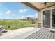 Covered back porch with a view of open space and a neighboring home at 27196 E Alder Dr, Aurora, CO 80016