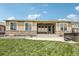 Backyard view with lawn, patio, hot tub, and large windows providing abundant natural light at 27196 E Alder Dr, Aurora, CO 80016
