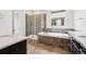 Luxurious bathroom boasting a soaking tub, tiled shower, and sleek vanity with stone countertop at 27196 E Alder Dr, Aurora, CO 80016