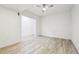 Well-lit bedroom featuring wood look floors, a ceiling fan, and neutral walls at 27196 E Alder Dr, Aurora, CO 80016