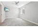 Bedroom with light gray walls, plush carpeting, ceiling fan, and TV mounted on the wall at 27196 E Alder Dr, Aurora, CO 80016
