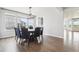 A dining area with hardwood floors, a modern chandelier, and large windows at 27196 E Alder Dr, Aurora, CO 80016