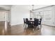 A dining area with hardwood floors, large windows, and a modern chandelier at 27196 E Alder Dr, Aurora, CO 80016