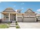 Charming, two-story home featuring stone accents, a covered porch, and an attached two-car garage at 27196 E Alder Dr, Aurora, CO 80016
