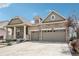 Charming two-story home with stone accents, covered porch, and attached two-car garage at 27196 E Alder Dr, Aurora, CO 80016