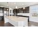 Modern kitchen boasts stainless steel appliances, dark cabinetry, and granite countertops at 27196 E Alder Dr, Aurora, CO 80016