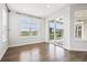 Bright living room with hardwood floors, large windows and sliding door offering a view at 27196 E Alder Dr, Aurora, CO 80016
