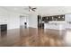 Open floor plan featuring dark hardwood floors, a fireplace, and a modern kitchen at 27196 E Alder Dr, Aurora, CO 80016
