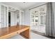 Bright home office area featuring wood desk and doors leading to outside living at 27196 E Alder Dr, Aurora, CO 80016