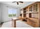 Study featuring wood desk, cabinets, and lots of light at 27196 E Alder Dr, Aurora, CO 80016
