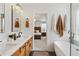 Bathroom with double vanity and view into bedroom at 5935 E 129Th Pl, Thornton, CO 80602