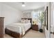 Bright bedroom with wood furniture and window coverings at 5935 E 129Th Pl, Thornton, CO 80602