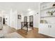 Spacious entryway with built-in shelving and hardwood floors at 5935 E 129Th Pl, Thornton, CO 80602