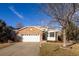 Brick ranch home with attached garage and landscaped yard at 5935 E 129Th Pl, Thornton, CO 80602