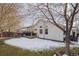 Back exterior of house showing white siding, deck, and snow covered yard at 5935 E 129Th Pl, Thornton, CO 80602