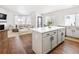 Modern kitchen with island, white cabinets, and stainless steel appliances at 5935 E 129Th Pl, Thornton, CO 80602