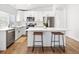 Modern kitchen with white cabinets, quartz countertops, and island with seating at 5935 E 129Th Pl, Thornton, CO 80602