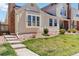 Charming home exterior with light siding, well-kept landscaping, and brick accents at 7722 S Steele St, Centennial, CO 80122