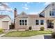 Well-kept home exterior with a brick chimney, stone details, and a manicured lawn at 7722 S Steele St, Centennial, CO 80122