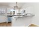 Kitchen with stainless steel appliances, white cabinets, granite counters, and ample natural light at 7722 S Steele St, Centennial, CO 80122