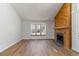 Bright living room featuring a wooden fireplace, large windows, and natural light at 7722 S Steele St, Centennial, CO 80122