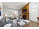 Bright living room with vaulted ceilings, modern furniture and wooden fireplace with mounted television at 7722 S Steele St, Centennial, CO 80122