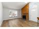Bright living room featuring a wooden fireplace, large windows, and natural light at 7722 S Steele St, Centennial, CO 80122
