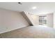Carpeted living room with staircase and sliding glass doors at 7722 S Steele St, Centennial, CO 80122