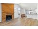 Open-concept living room with a wooden fireplace and access to the kitchen and entryway at 7722 S Steele St, Centennial, CO 80122