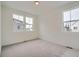 Simple bedroom with light gray carpeting and two windows at 14556 W 91St Ave # A, Arvada, CO 80005