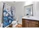 Bathroom with unique shower curtain and white vanity at 28304 E 6Th Pl, Watkins, CO 80137