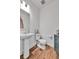 Stylish half bathroom features modern fixtures and wood-look flooring at 28304 E 6Th Pl, Watkins, CO 80137
