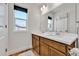 Bright bathroom featuring double sinks, wood-look flooring and modern fixtures at 28304 E 6Th Pl, Watkins, CO 80137