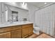 Bright bathroom with dual sinks, wood cabinets, and a shower/tub combo at 28304 E 6Th Pl, Watkins, CO 80137