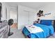 Cozy bedroom featuring a large window, modern decor, and carpeted flooring at 28304 E 6Th Pl, Watkins, CO 80137