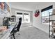 Bright room with a large window, carpeted floor, and modern gaming setup at 28304 E 6Th Pl, Watkins, CO 80137