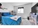 Cozy bedroom featuring a large window, modern decor, and carpeted flooring at 28304 E 6Th Pl, Watkins, CO 80137