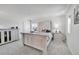 Bright bedroom with a neutral color palette, carpeted floors and vintage furniture pieces at 28304 E 6Th Pl, Watkins, CO 80137