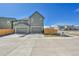 Modern two-story home with a two-car garage and large driveway with a privacy fence on a sunny day at 28304 E 6Th Pl, Watkins, CO 80137
