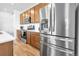 Stainless steel refrigerator, wood cabinets and white countertops are the centerpieces of this gorgeous kitchen at 28304 E 6Th Pl, Watkins, CO 80137