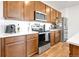 This beautifully-appointed kitchen offers stainless steel appliances, wood cabinets, and white countertops at 28304 E 6Th Pl, Watkins, CO 80137