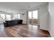 Open living room featuring hardwood floors, sliding doors, and ample natural light at 28304 E 6Th Pl, Watkins, CO 80137
