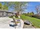 Charming backyard with patio seating, lush greenery, and a classic fire pit, perfect for outdoor relaxation at 6434 S Dudley Way, Littleton, CO 80123