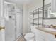 Bathroom featuring tiled shower, vanity, mirror and shelving unit at 6434 S Dudley Way, Littleton, CO 80123