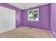 Bedroom with purple walls, chandelier, and a window offering natural light at 6434 S Dudley Way, Littleton, CO 80123