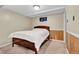 A simple bedroom with a comfortable bed, paneled walls, and neutral tones, creating a relaxing atmosphere at 6434 S Dudley Way, Littleton, CO 80123