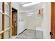 Functional laundry room with modern appliances, practical shelving, and durable tile flooring for easy maintenance at 6434 S Dudley Way, Littleton, CO 80123