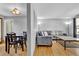 Open concept living room with dining area and gray sofa at 6434 S Dudley Way, Littleton, CO 80123