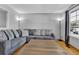 Inviting living room showcasing a comfortable gray sofa and natural light at 6434 S Dudley Way, Littleton, CO 80123